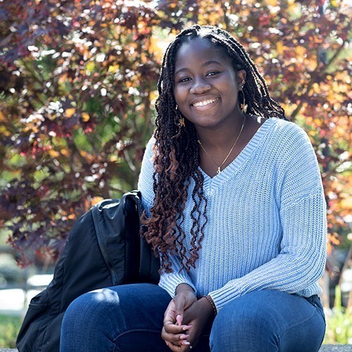 Student seated on campus grounds